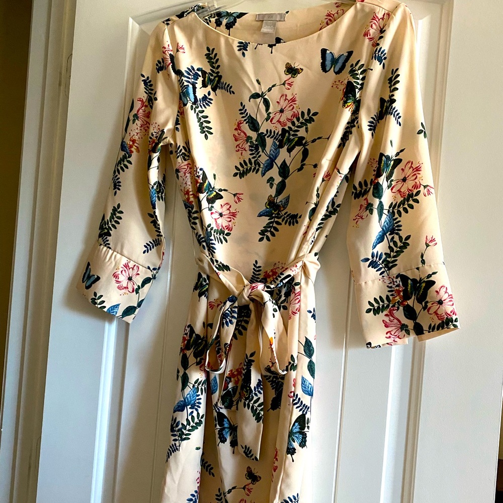 Cream colored dress with flowers.